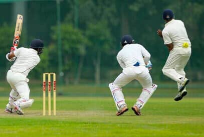 students playing cricket